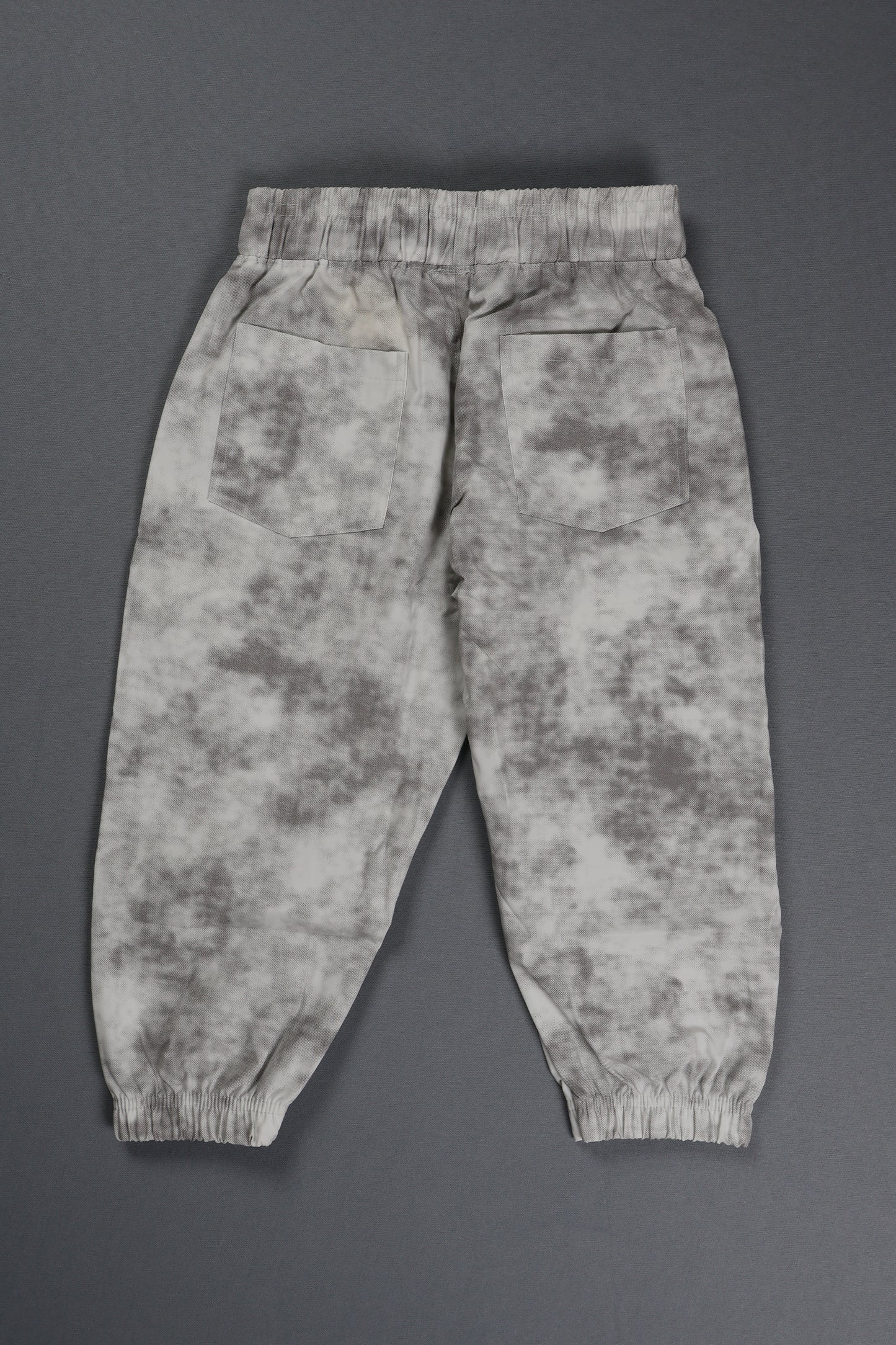 Camouflage-patterned pants on a gray background