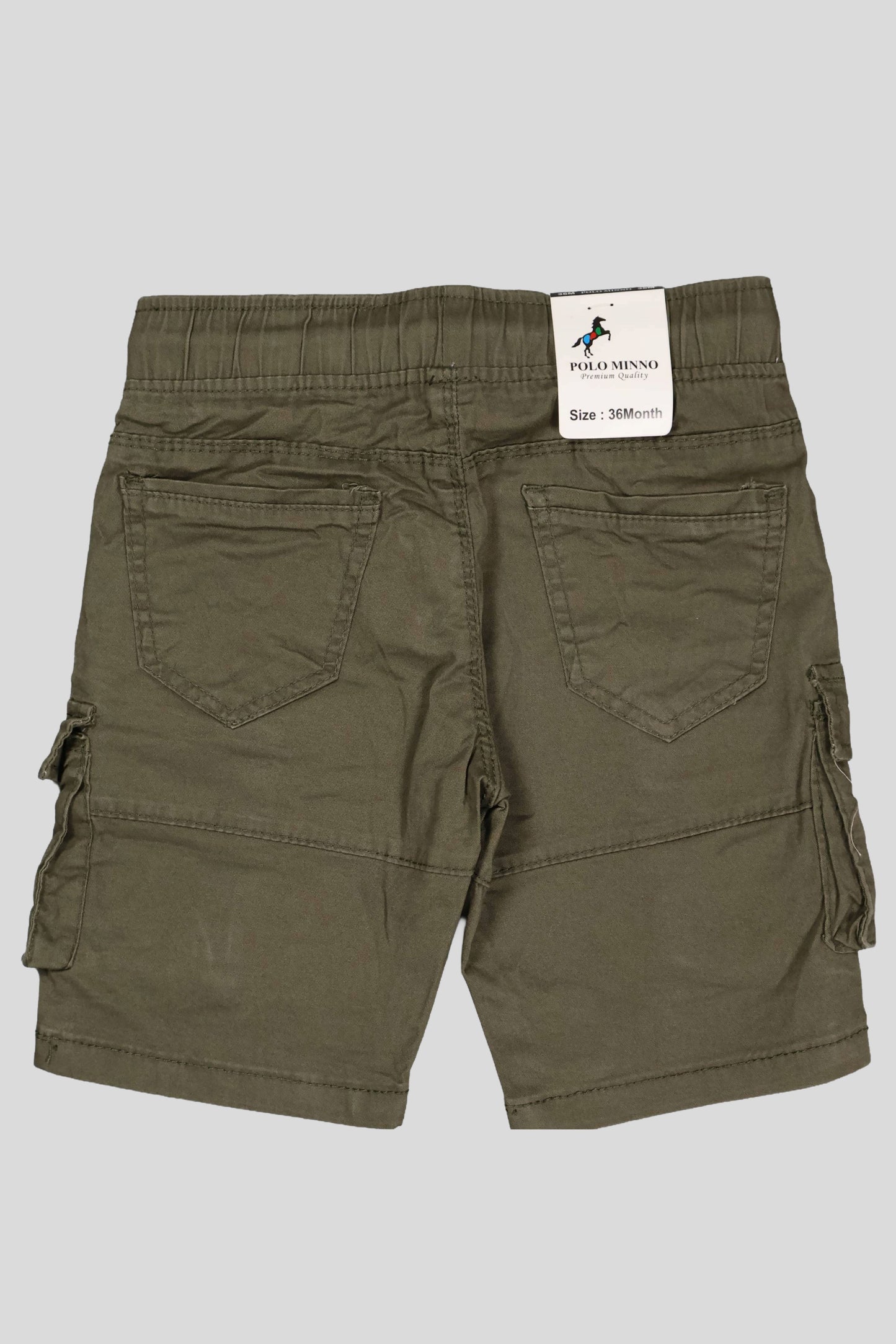 Green cargo shorts with a brand label on a gray background