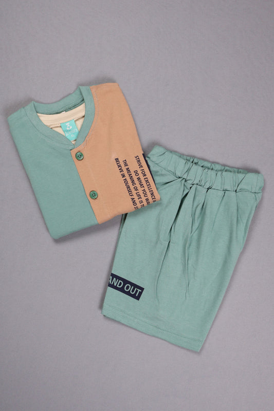 Green children's outfit with a label on a gray background