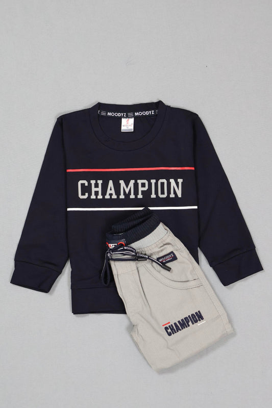 Navy sweatshirt and beige pants with 'Champion' branding on a gray background