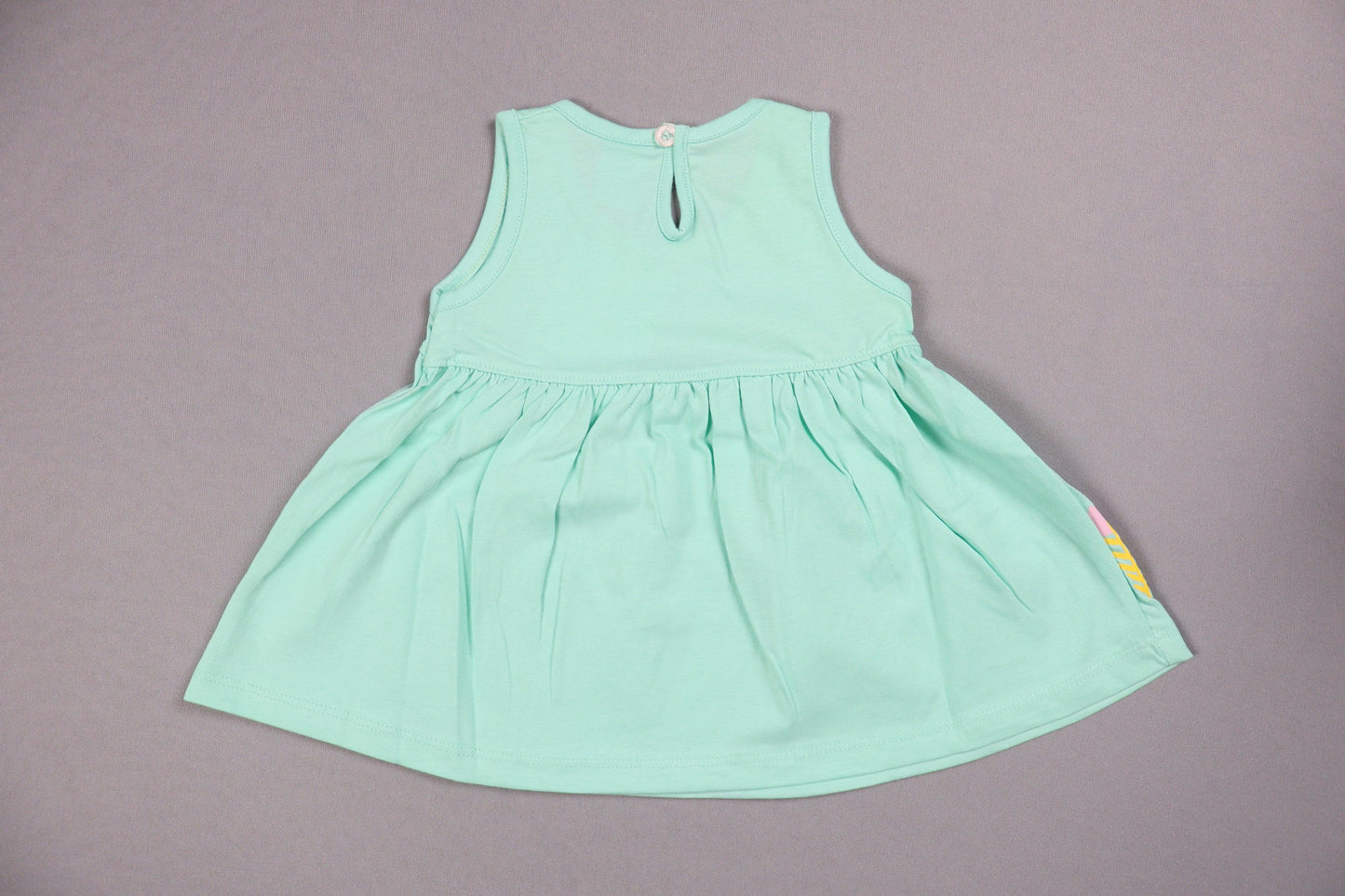 Sea green cotton knit frock for baby girls, sleeveless, back button, on grey background