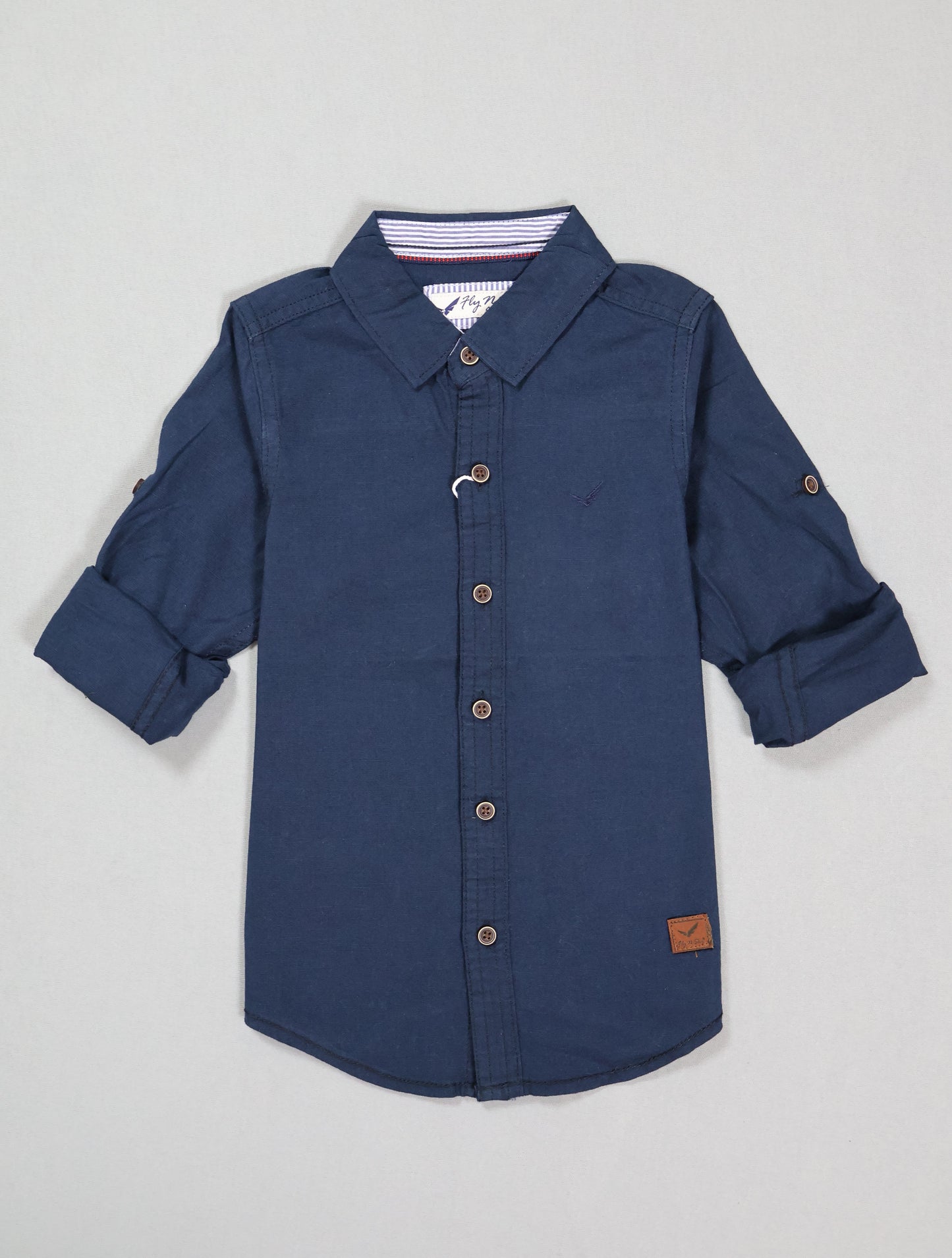 Blue button-up shirt with rolled-up sleeves on a light gray background