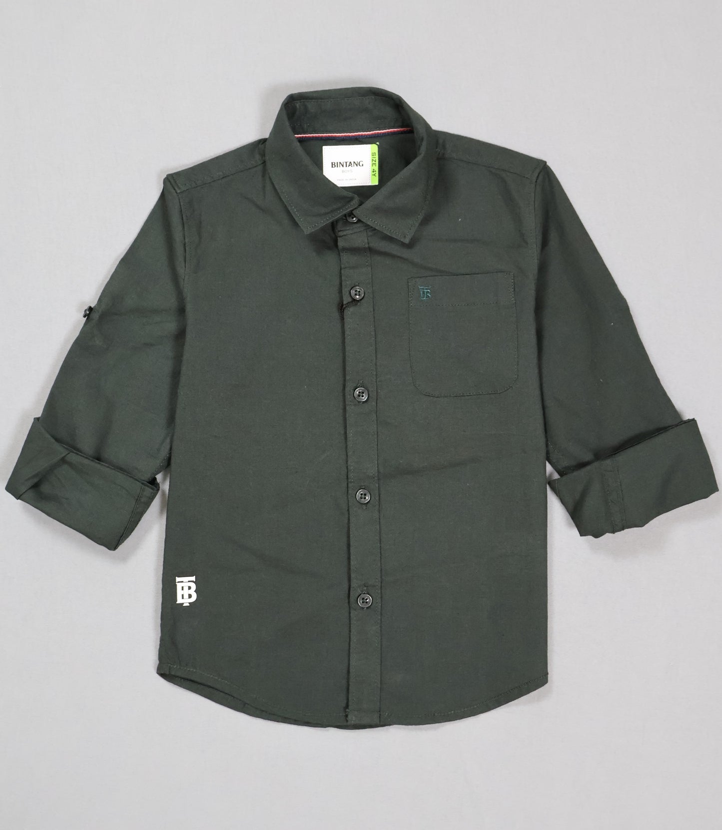 Green shirt with rolled-up sleeves on a gray background