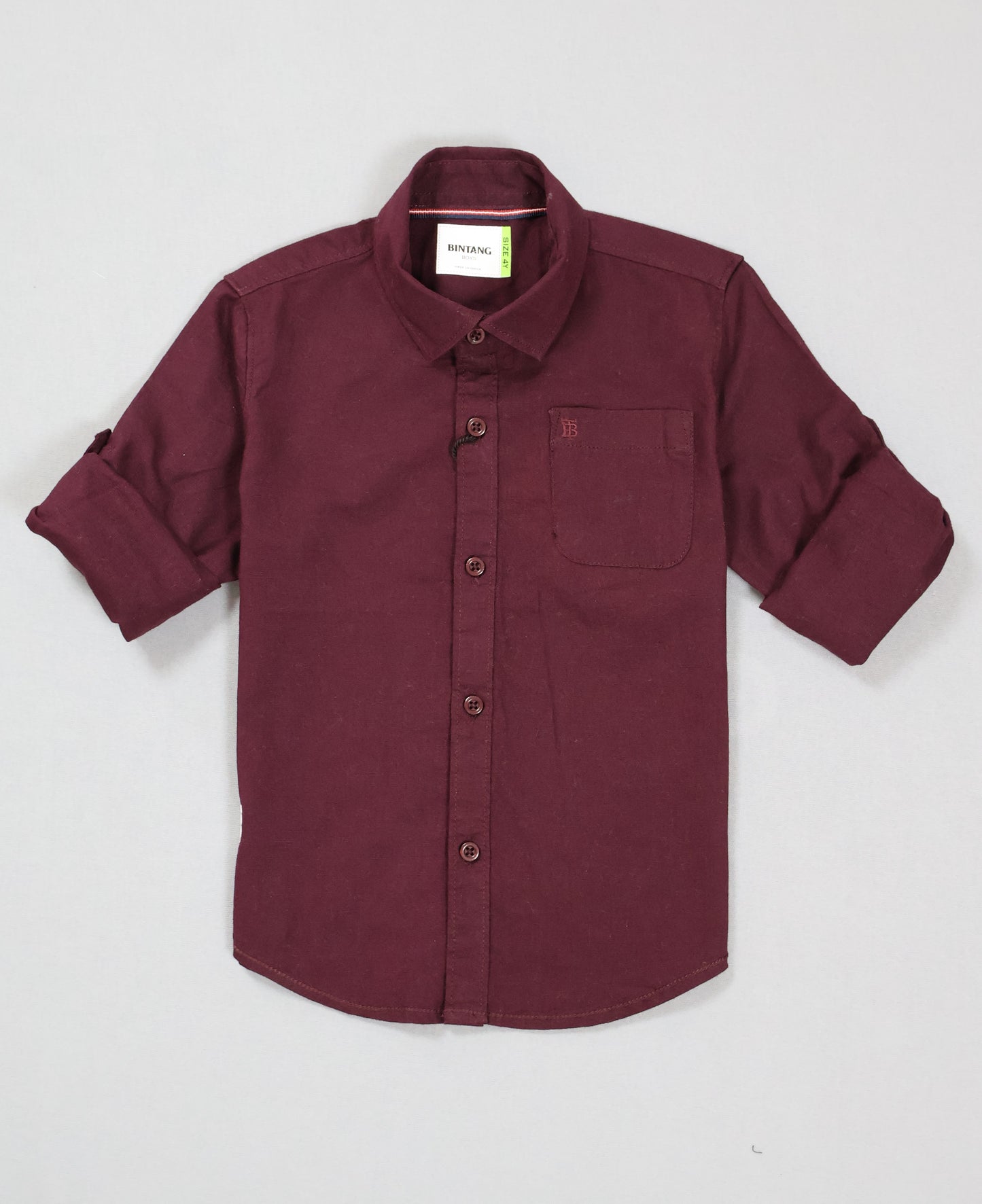 Maroon shirt with rolled-up sleeves on a light gray background