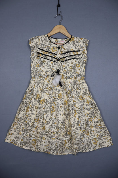 Girls' sleeveless cotton floral dress in yellow and grey with black lace trim, displayed on hanger.