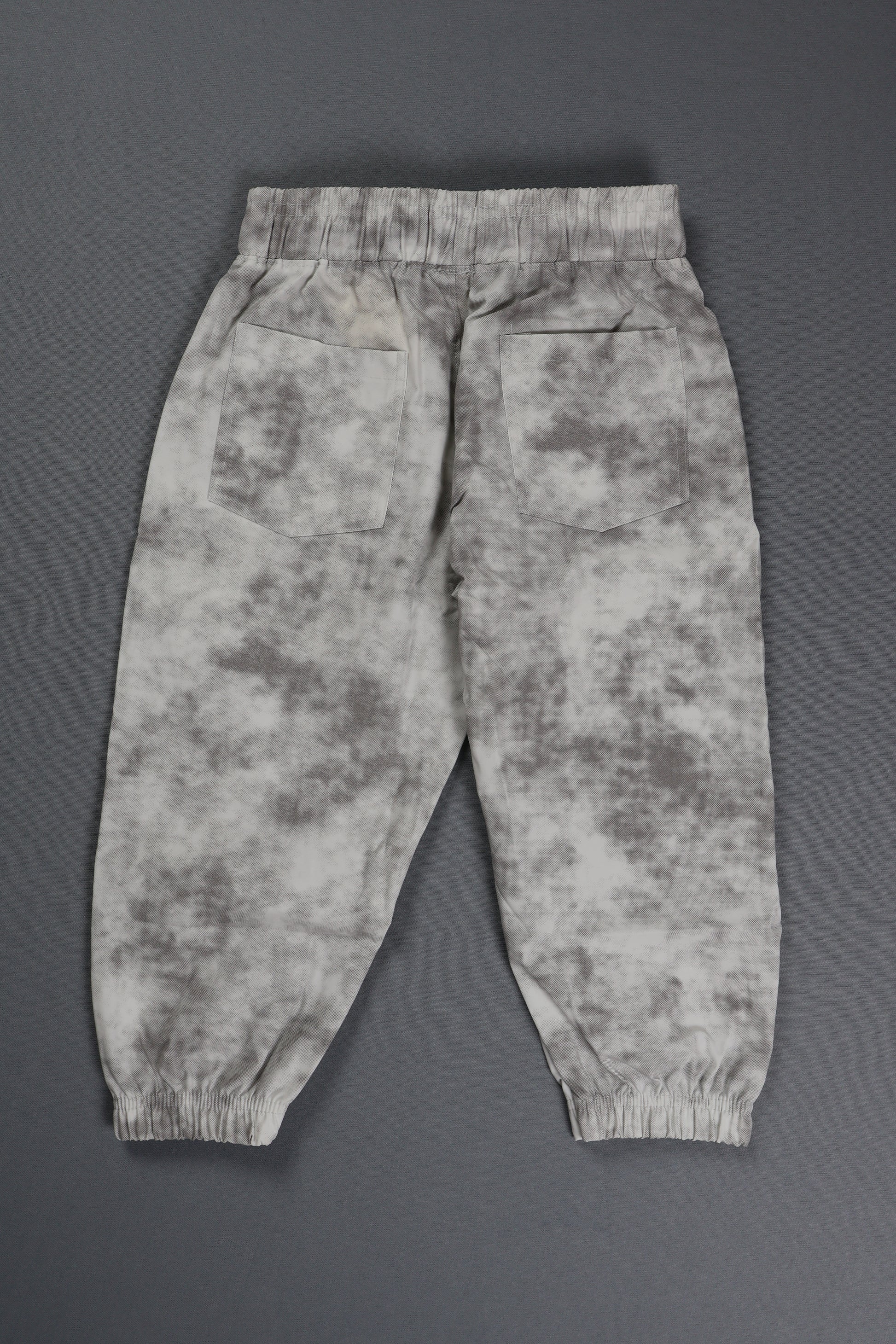 Camouflage-patterned pants on a gray background
