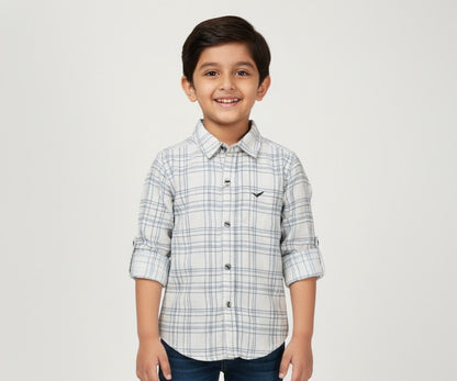 Child wearing a plaid shirt with a white background
