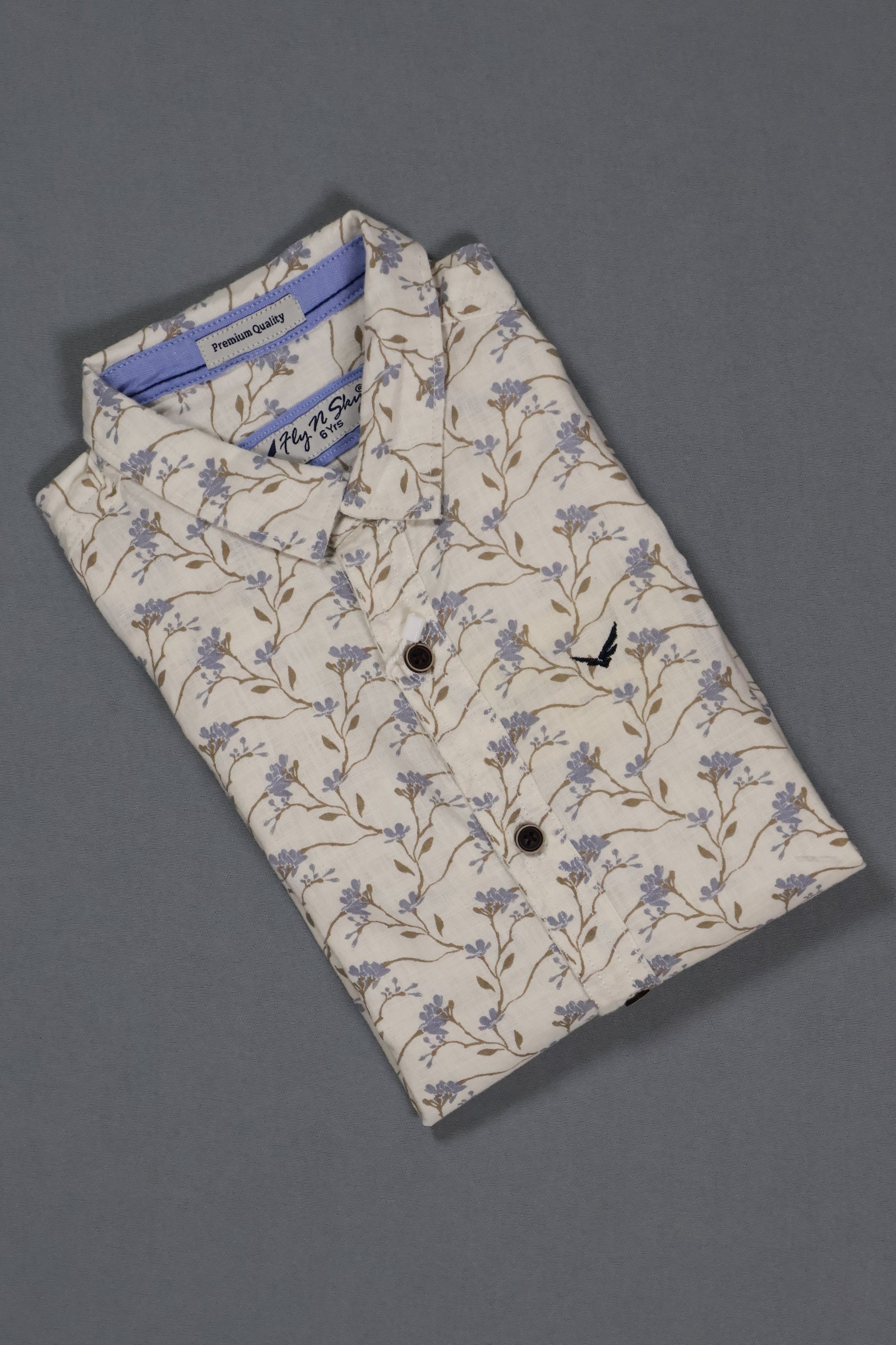 Folded shirt with floral pattern on a gray background