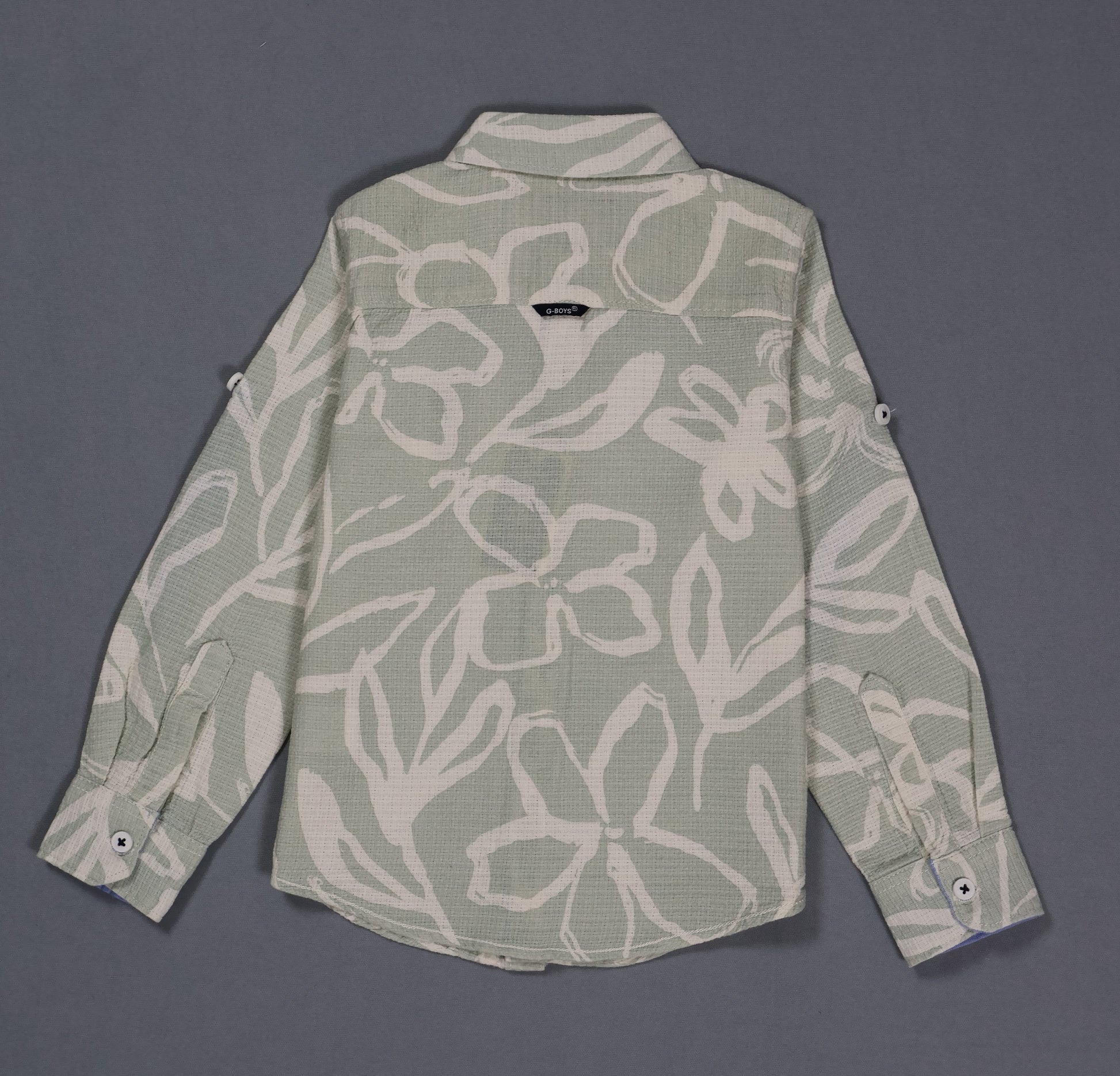 Green floral patterned shirt on a gray background