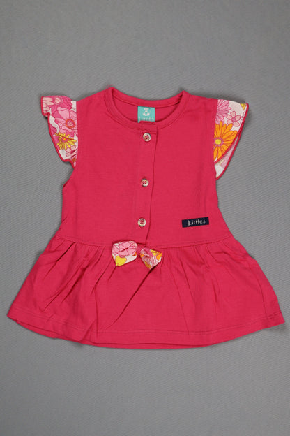 Pink dress with floral details on a gray background
