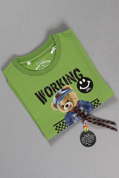 Green t-shirt with teddy bear design and 'Working' text on a gray background