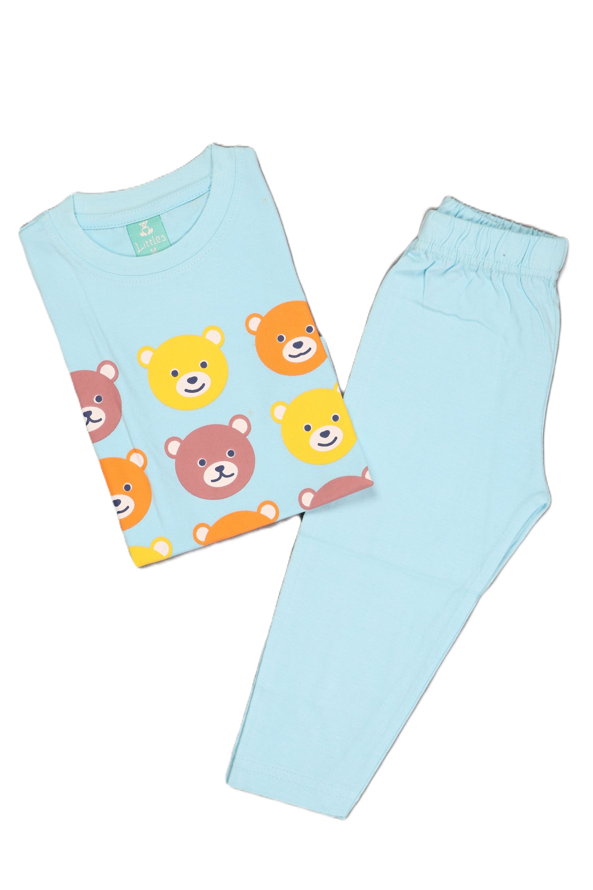A flat lay of a light blue children's long-sleeve pajama set. The folded top features a repeating grid pattern of multicolored bear faces in yellow, orange, and brown, paired with matching solid light blue full-length pajama pants.