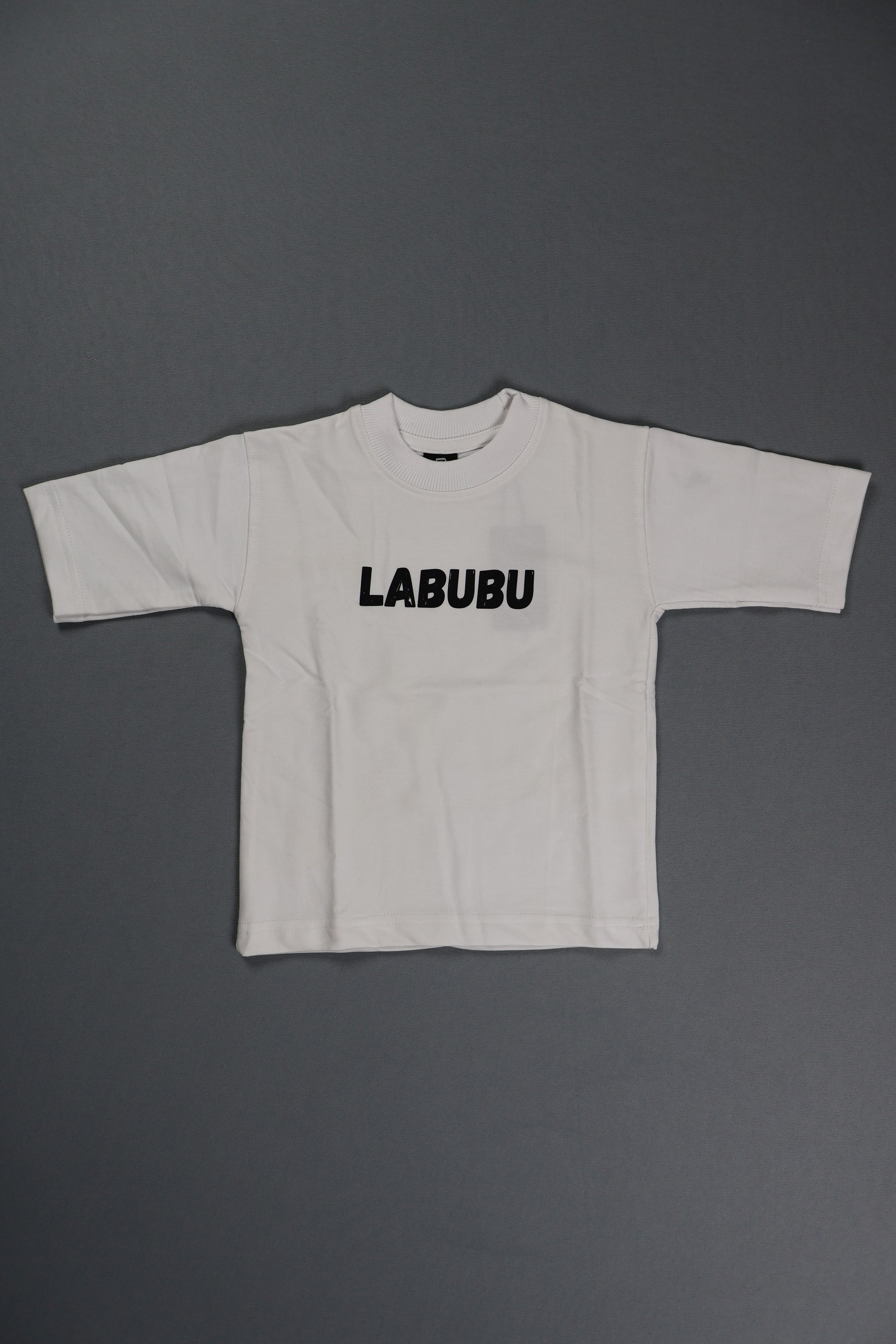 White sleeveless top with 'LABUBU' branding on a gray background