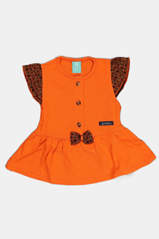 Orange dress with leopard print sleeves and buttons on a white background