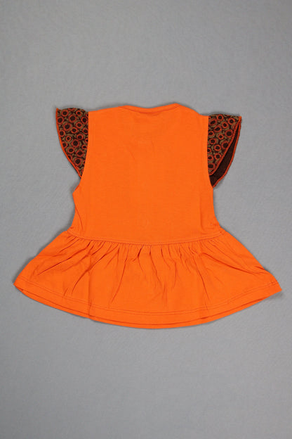 Orange dress with leopard print trim on a gray background