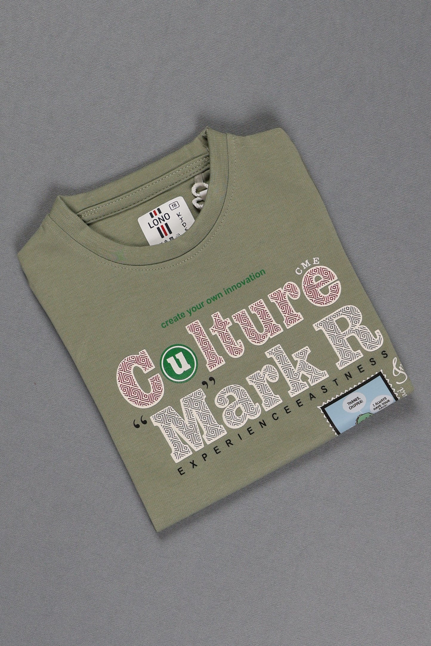 Green t-shirt with text and graphics on a gray background