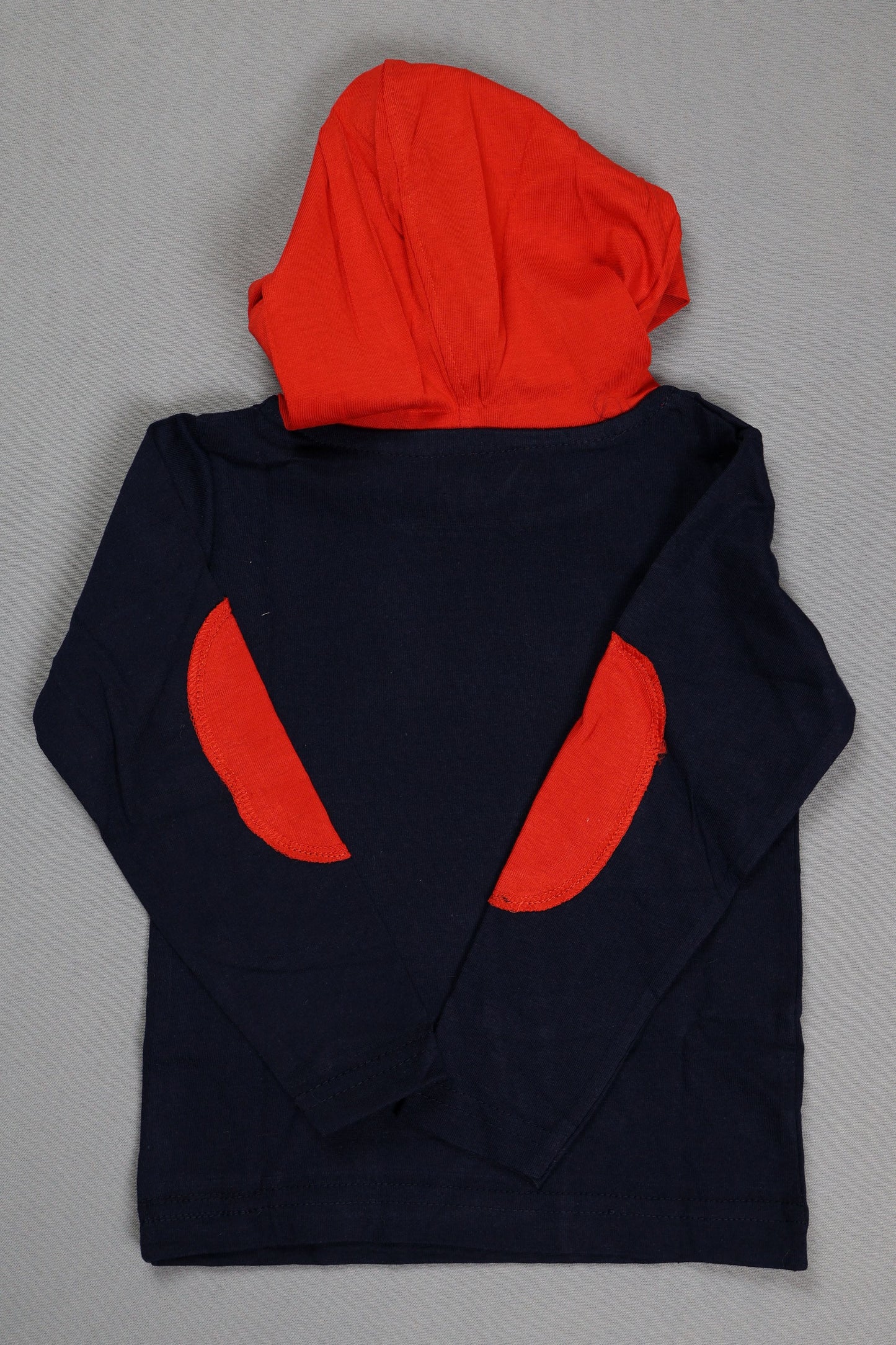 Navy blue fabric with red circular patterns on a gray background