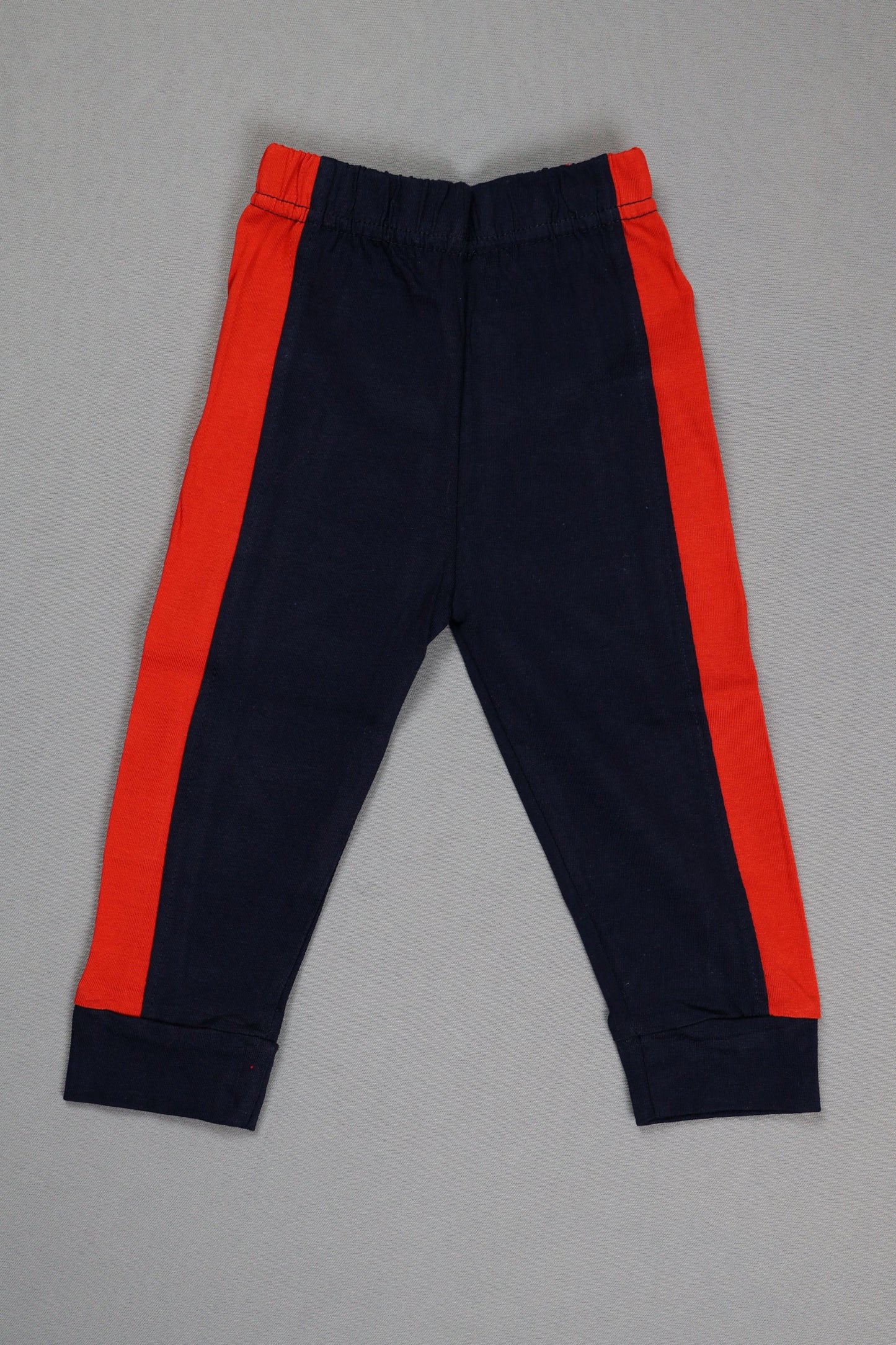 Navy pants with red accents on a gray background