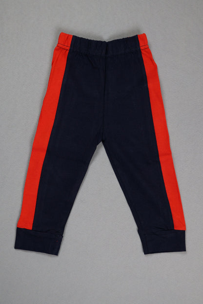 Navy pants with red accents on a gray background