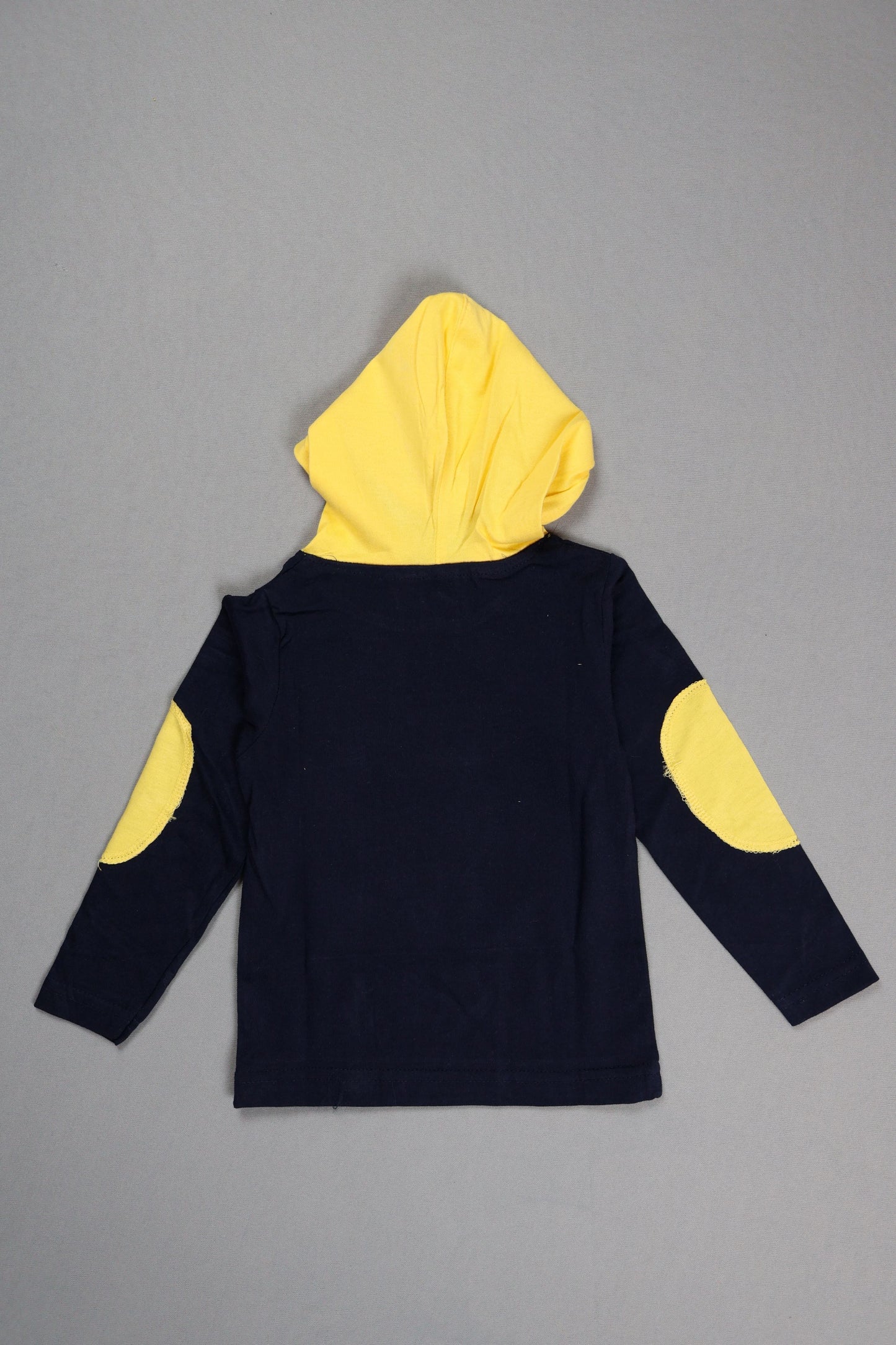 Black outfit with yellow circular patterns on a gray background