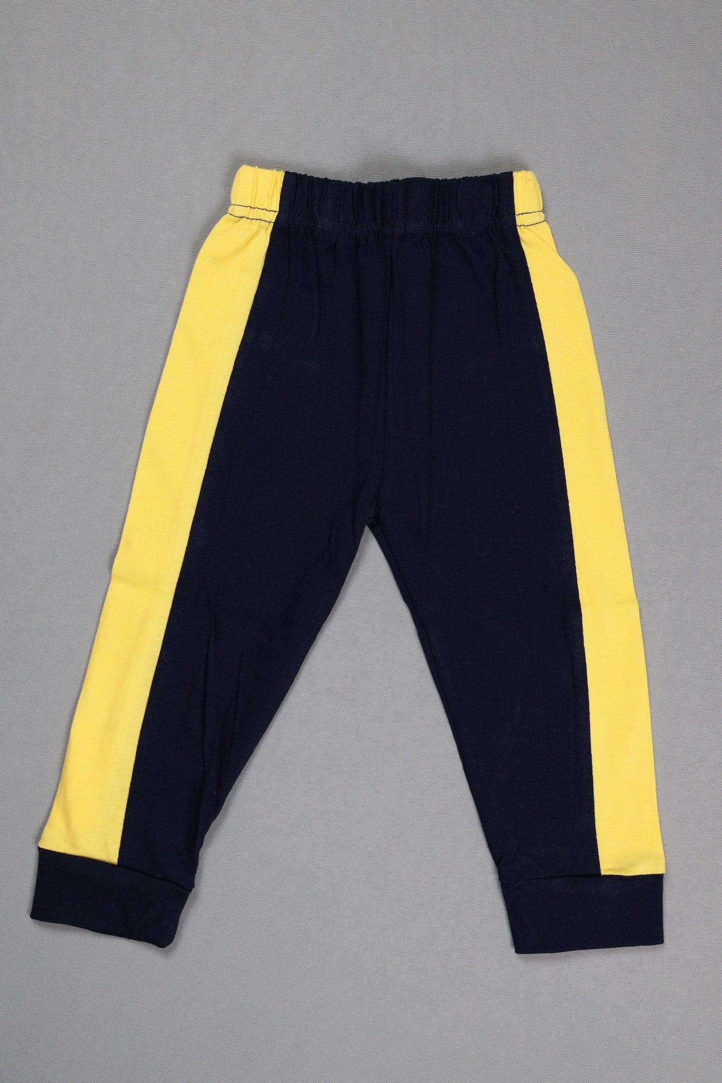 Black pants with yellow stripes on a gray background