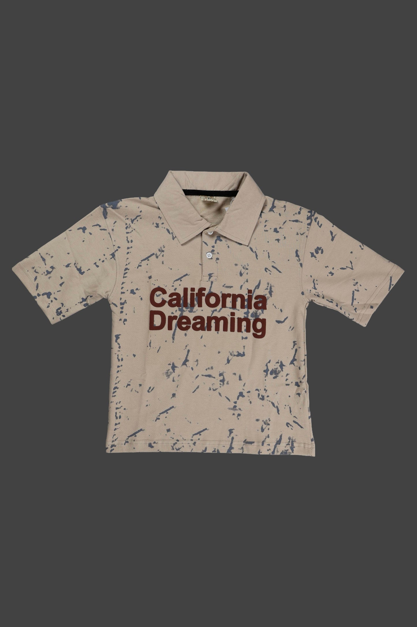 Beige polo shirt with 'California Dreaming' text on a dark background