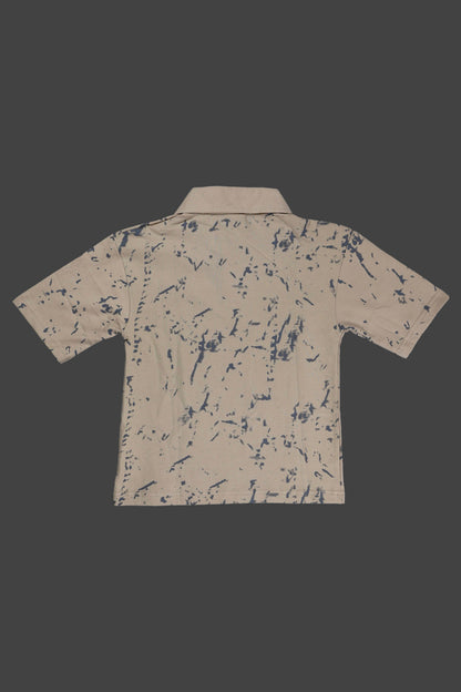 Beige shirt with blue abstract pattern on a black background
