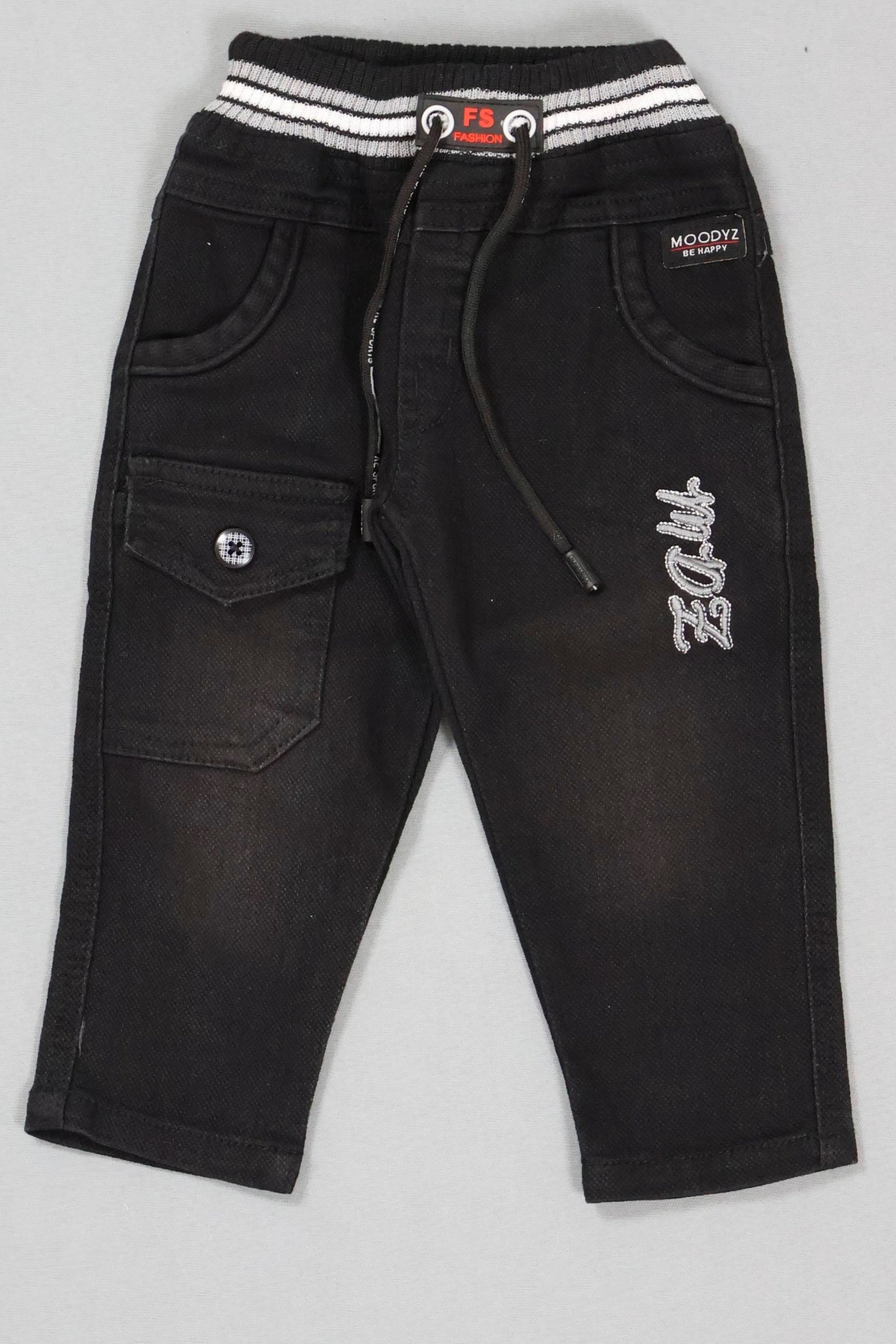 Black pants with white embroidery on a gray background