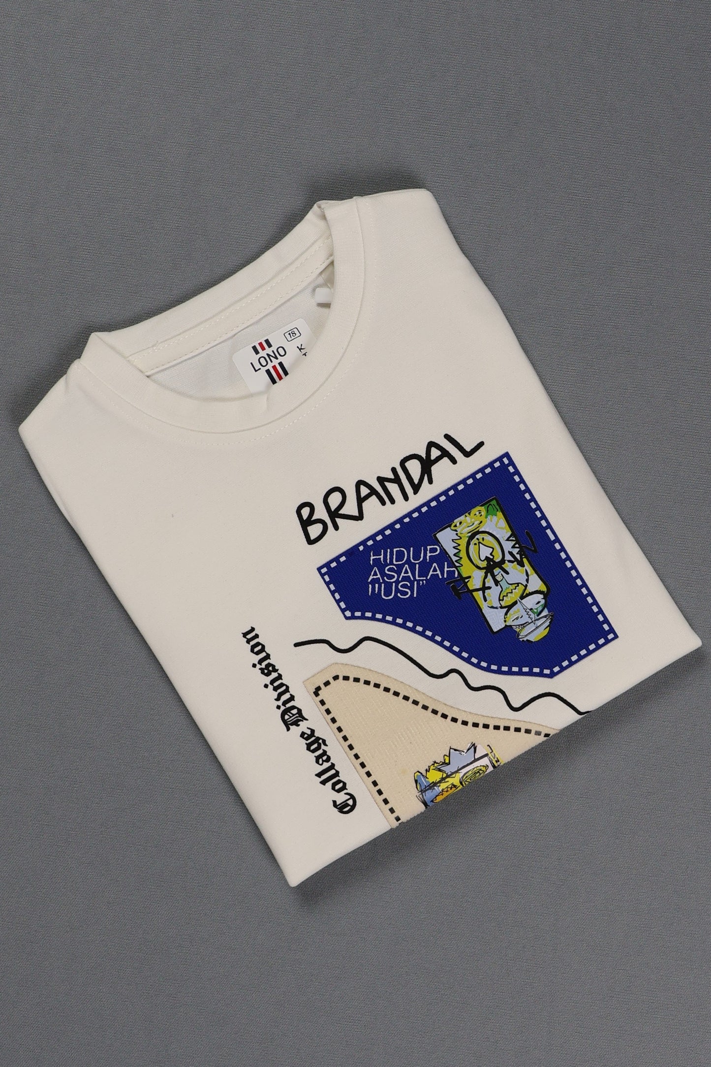 Folded white t-shirt with text and graphics on a gray background