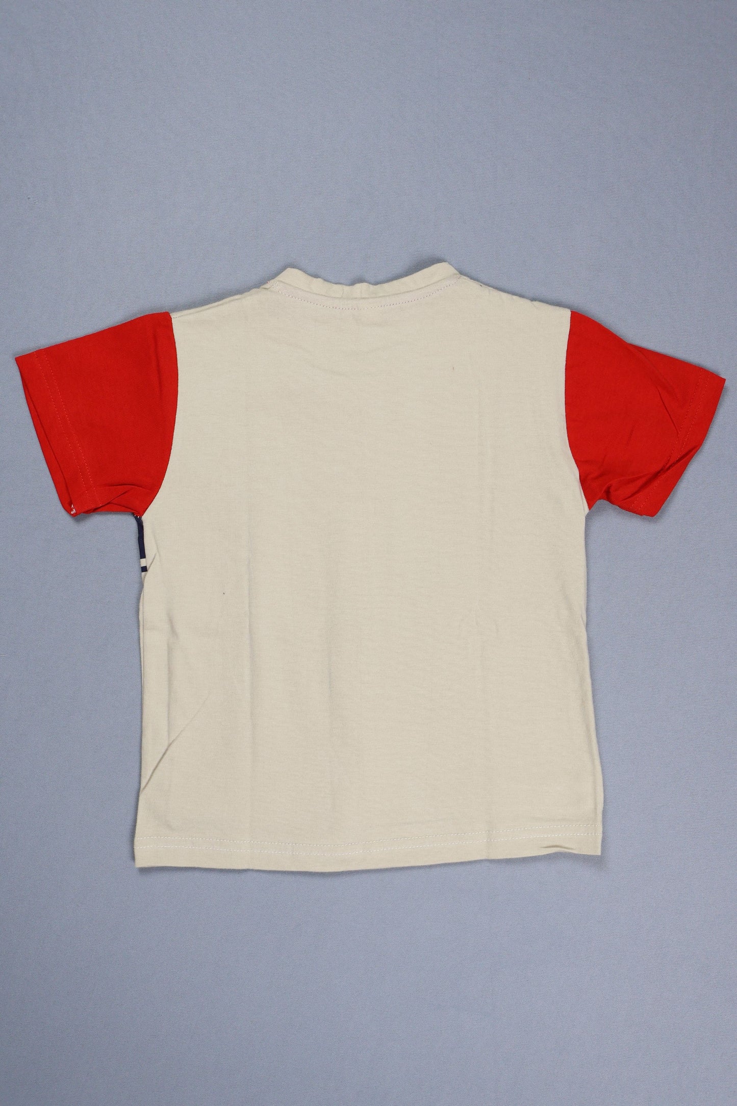 Beige garment with red trim on a gray background