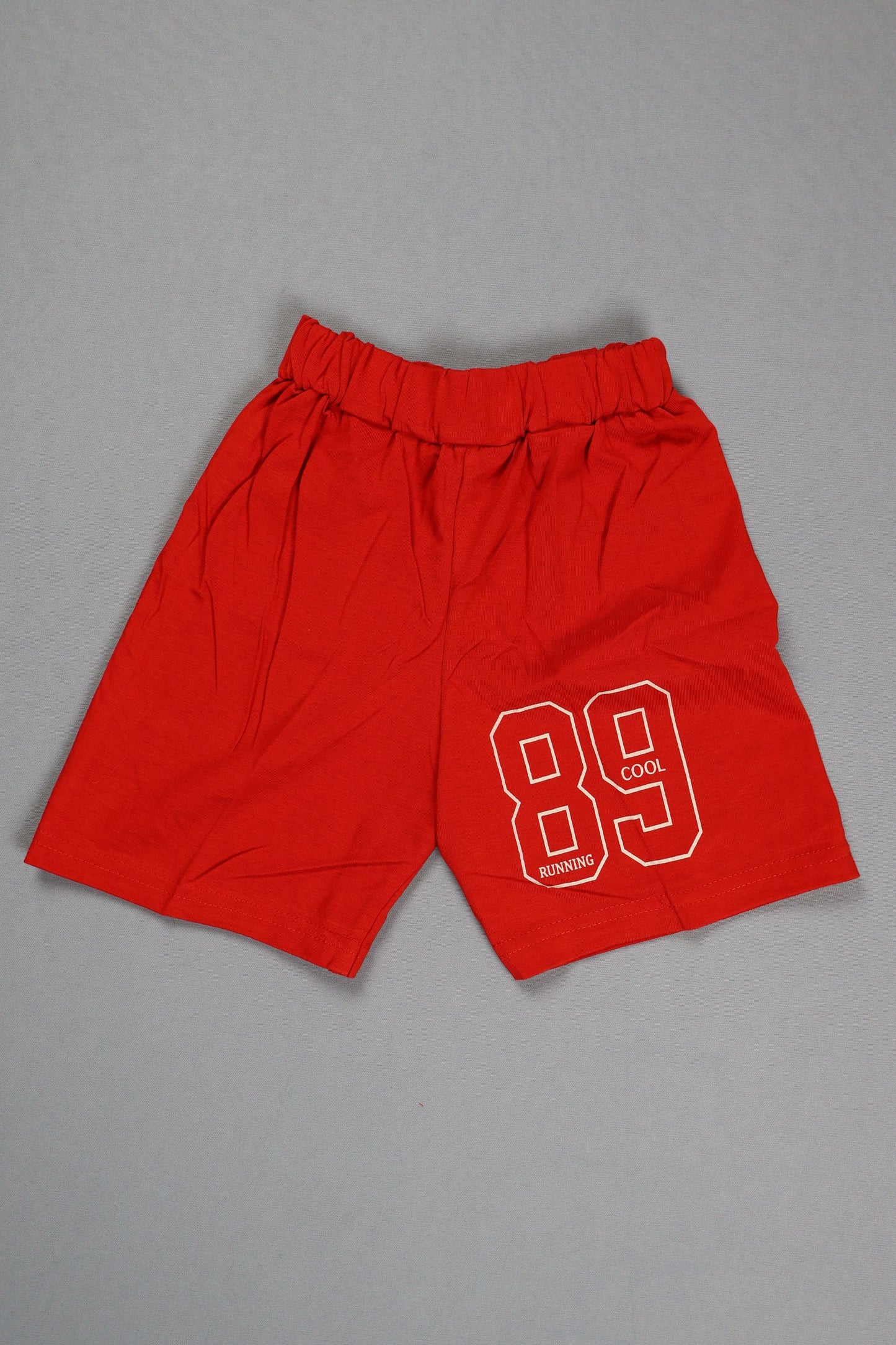 Red shorts with a white logo on a gray background