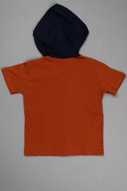 Orange t-shirt and black beanie on a gray background