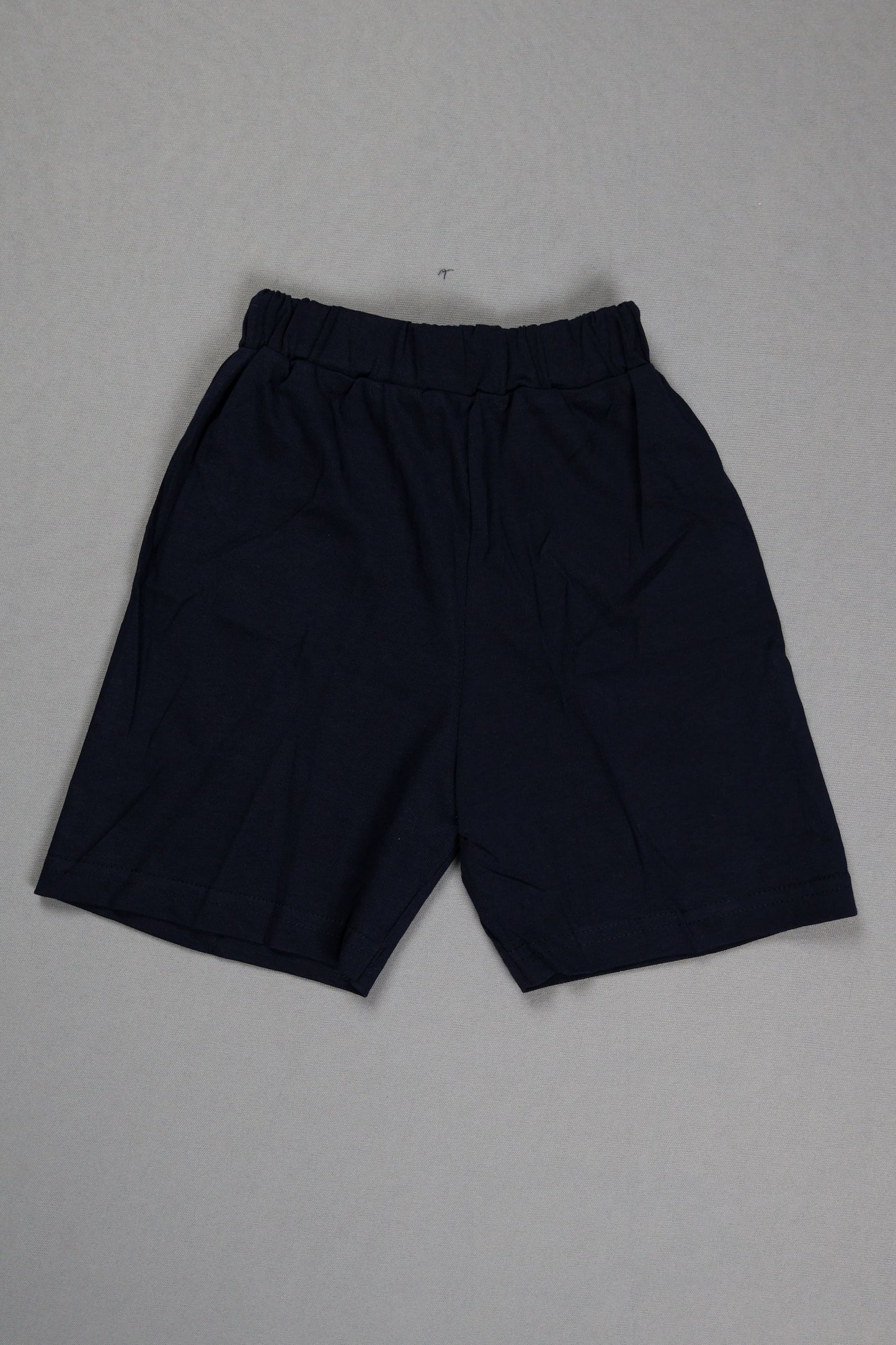 Pair of black pants on a gray background