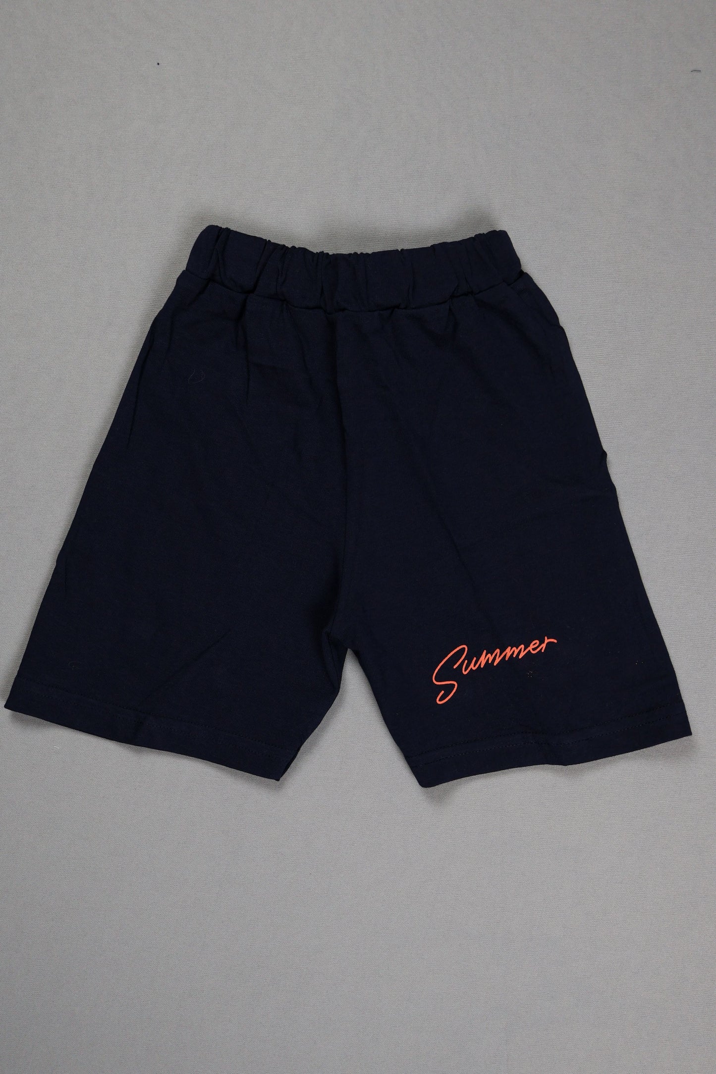 Black pants with orange text on a gray background