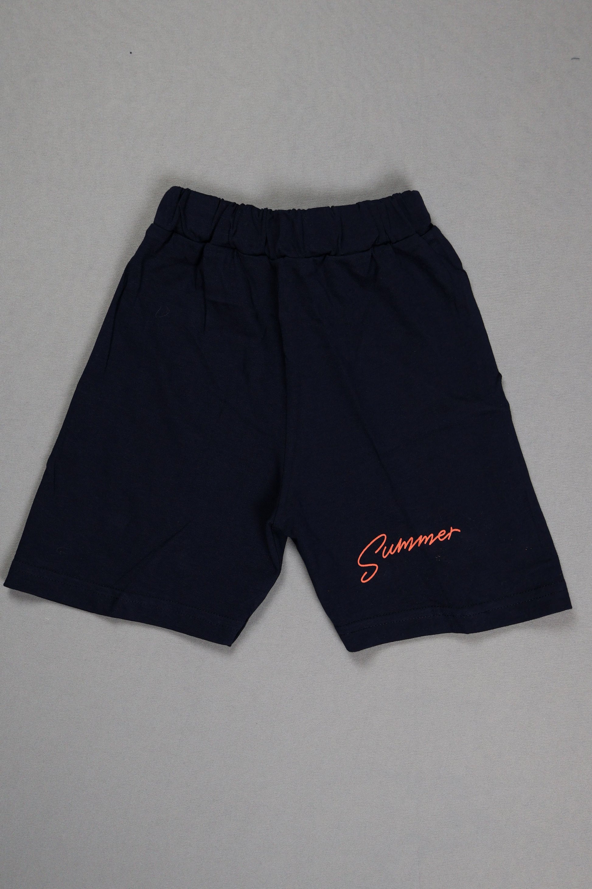 Black pants with orange text on a gray background