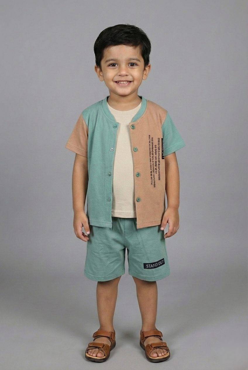 A young boy modeling a stylish three-piece summer set. The outfit features a sage green and sand brown color-block button-down shirt worn over a cream inner t-shirt, paired with matching sage green shorts. He is standing against a neutral grey background wearing brown sandals.