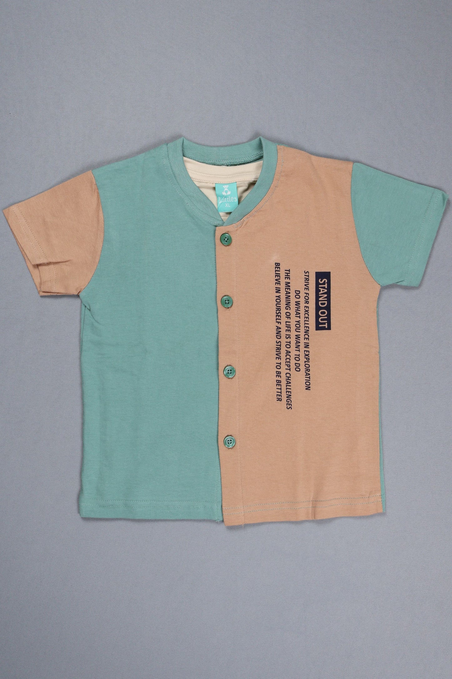 Children's dress with teal top and beige bottom on a gray background