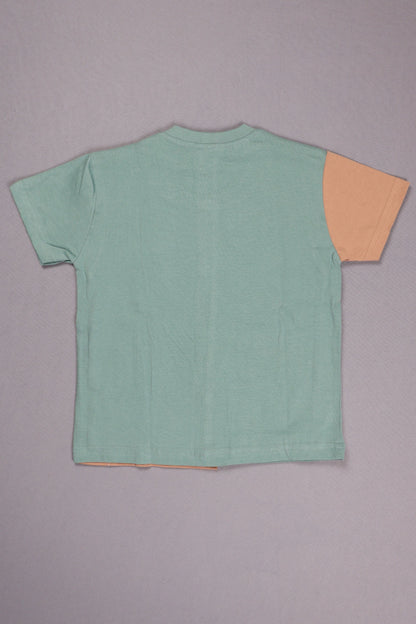 Green sleeveless top with orange trim on a gray background