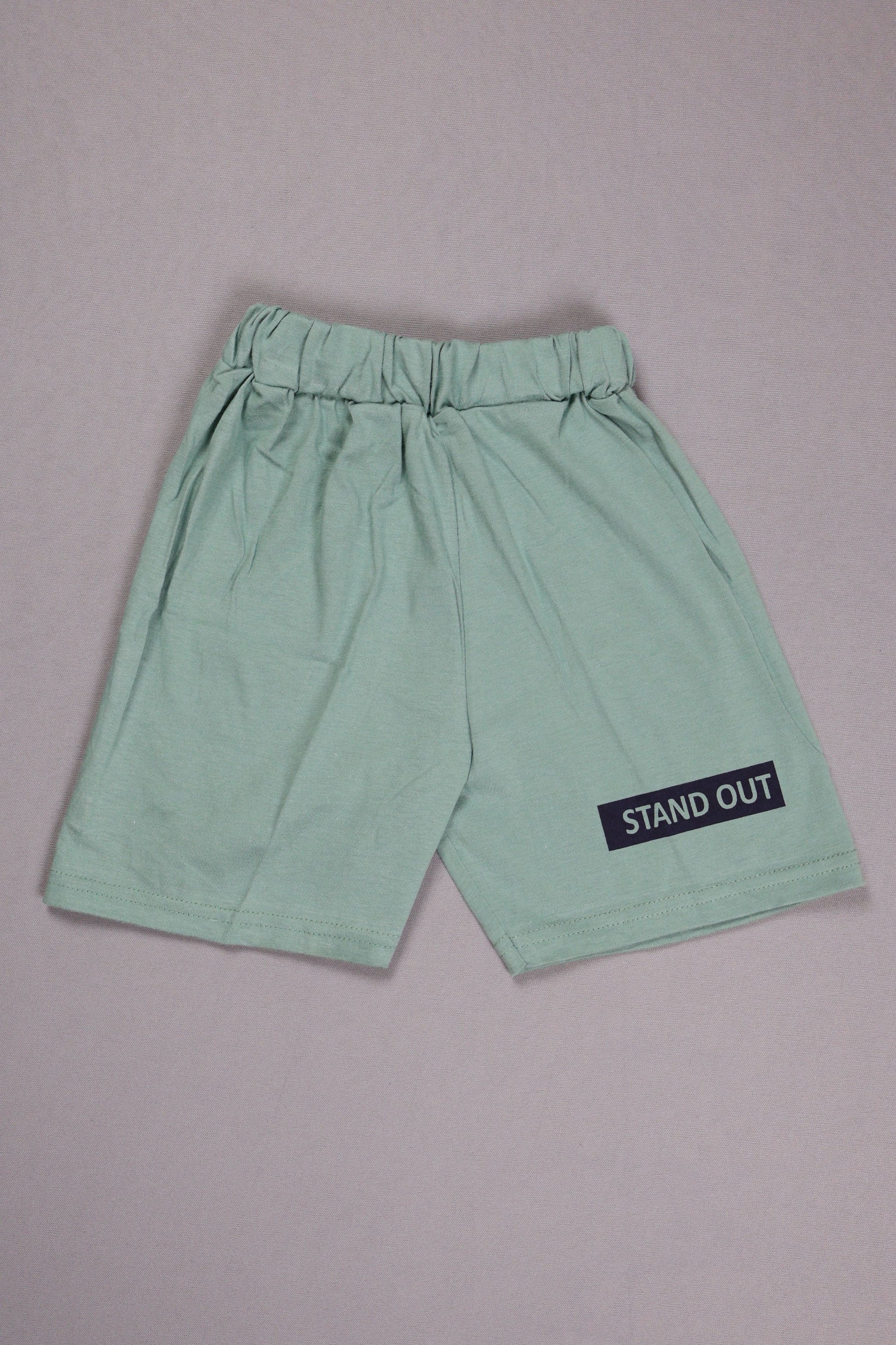 Light green shorts with a 'STAND OUT' label on a gray background