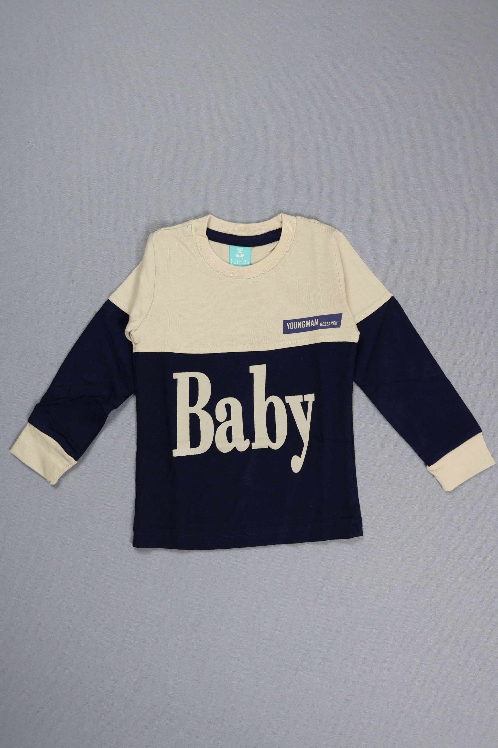 Navy and beige baby sweater with 'Baby' text on a gray background