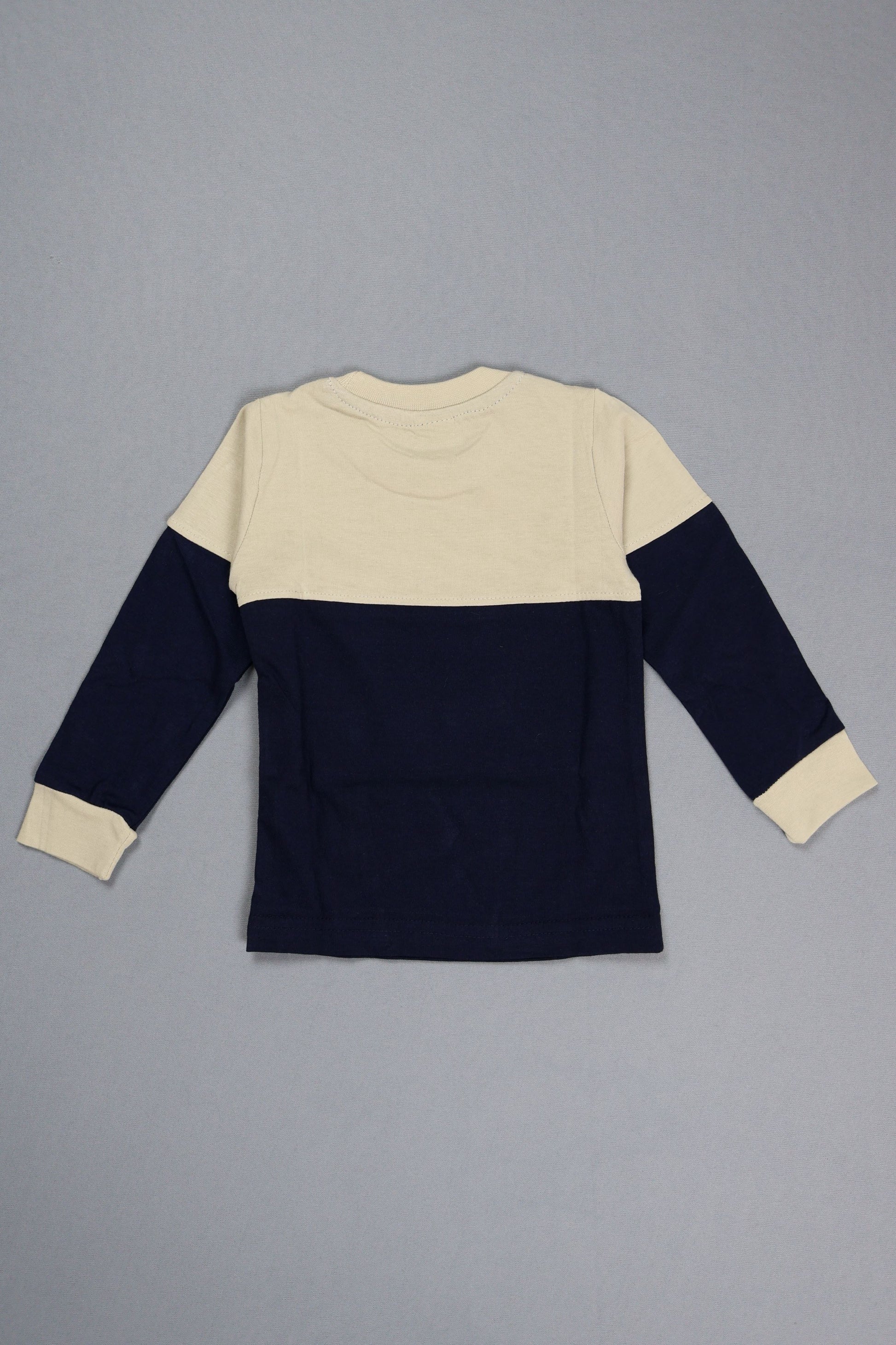 Navy and beige sweater on a gray background