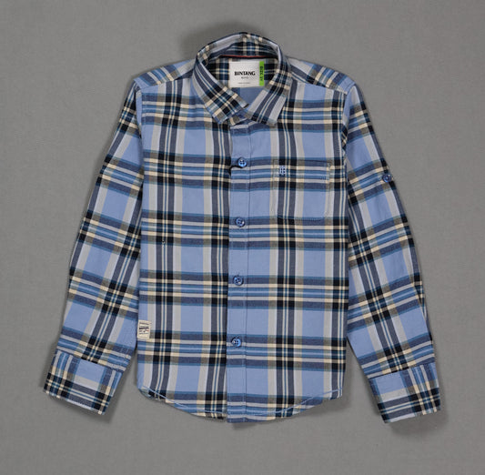 Blue and black plaid cotton kids shirt with long sleeves and front pocket on grey background