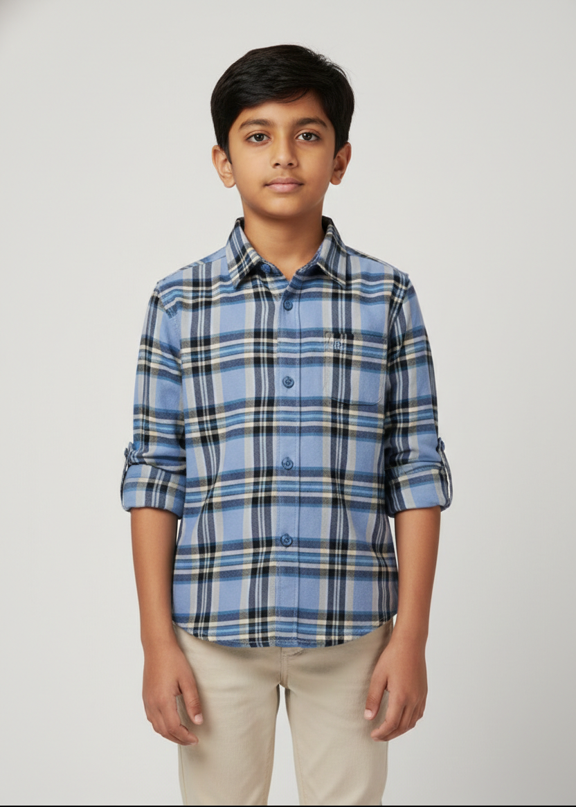 Boy in powder blue cotton checkered shirt with nautical grid pattern, long sleeves, beige pants