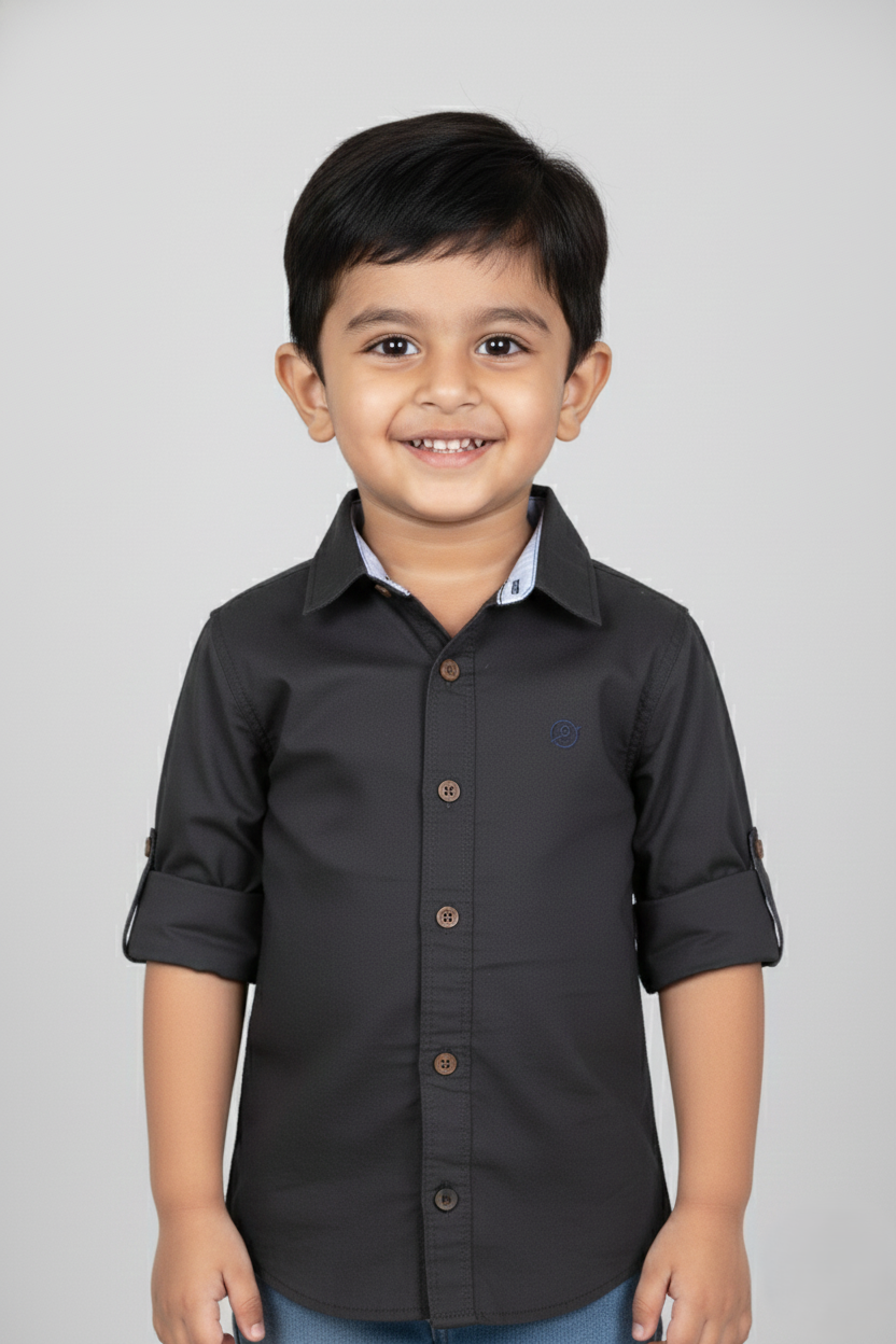 Fyst Boys' Charcoal Grey Solid Long-Sleeve Button-Down Shirt with Roll-Up Sleeve Tabs and Contrast Brown Buttons, worn by smiling child.