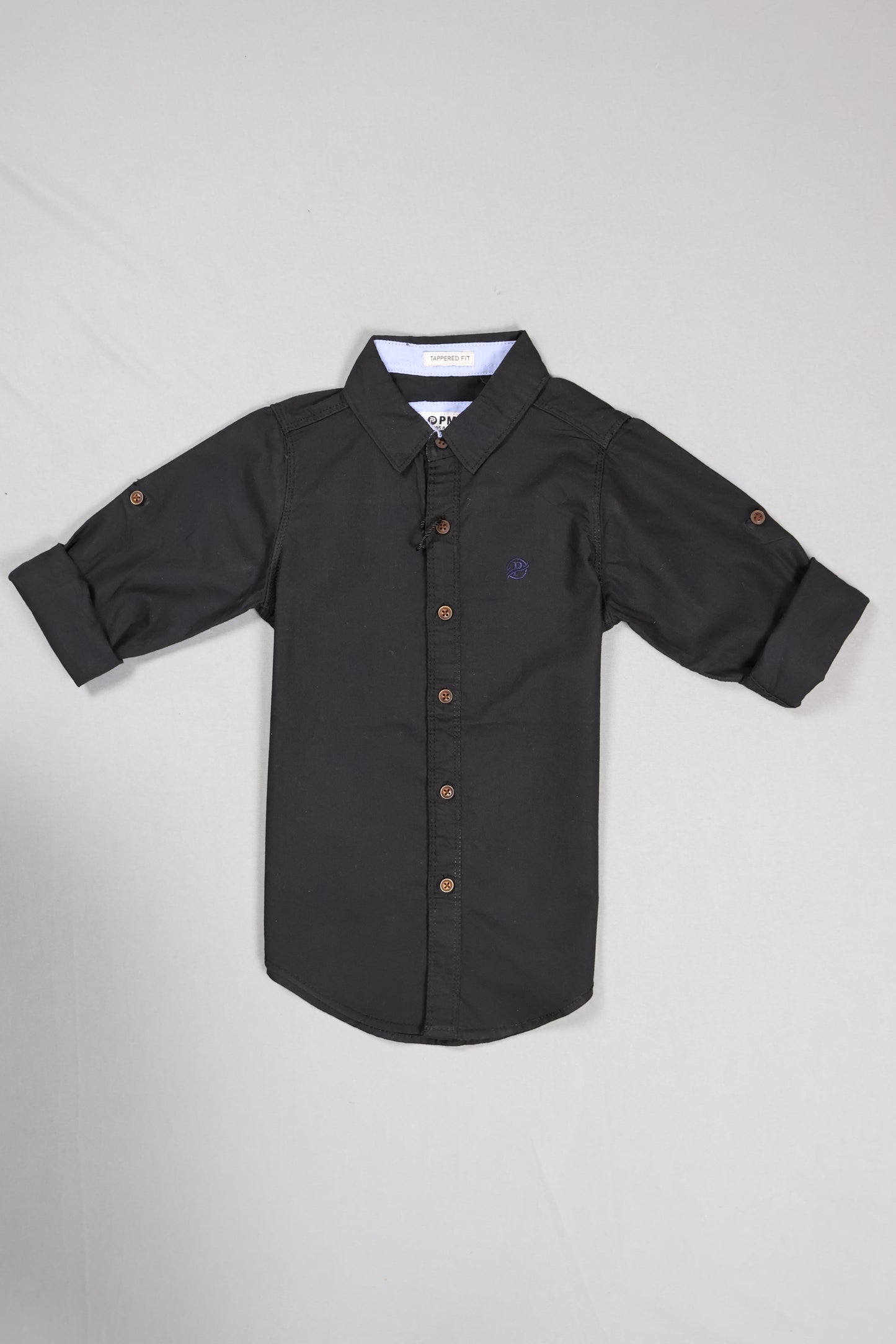Black baby onesie with buttons on a light gray background