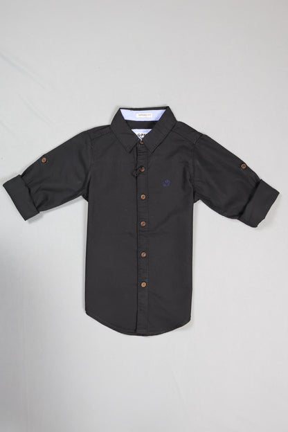 Black baby onesie with buttons on a light gray background