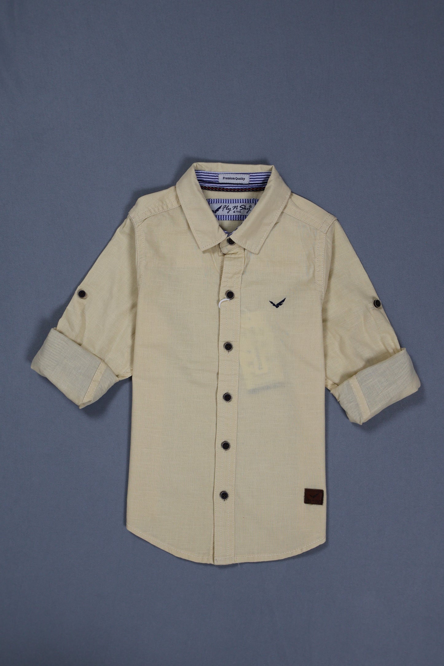 Beige jacket with black buttons on a gray background