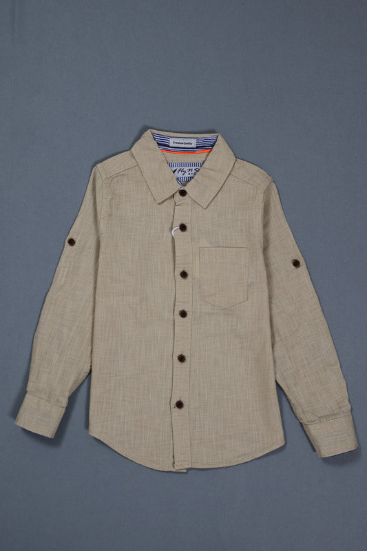 Fyst Boys' Beige Textured Long-Sleeve Button-Down Shirt with Single Chest Pocket and Roll-Up Sleeve Tabs, flat lay view on grey background.