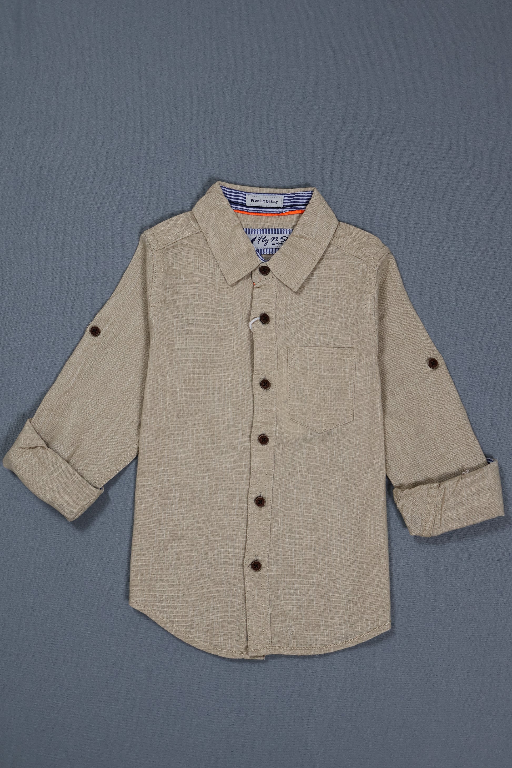 Beige shirt with buttons on a gray background