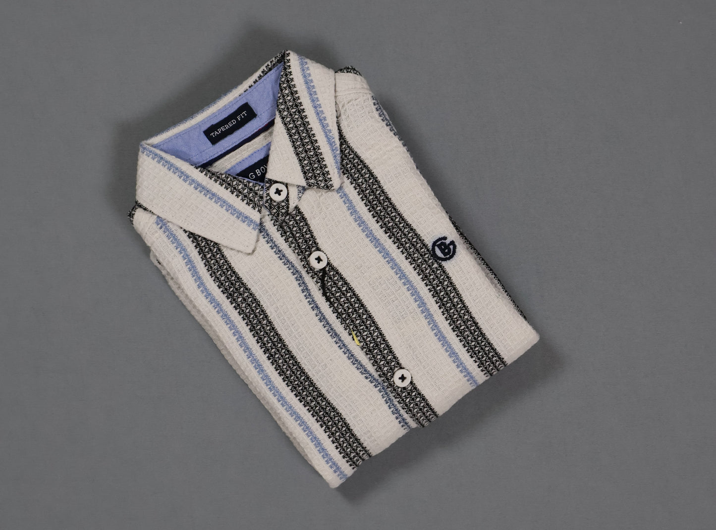 Folded striped shirt on a gray background